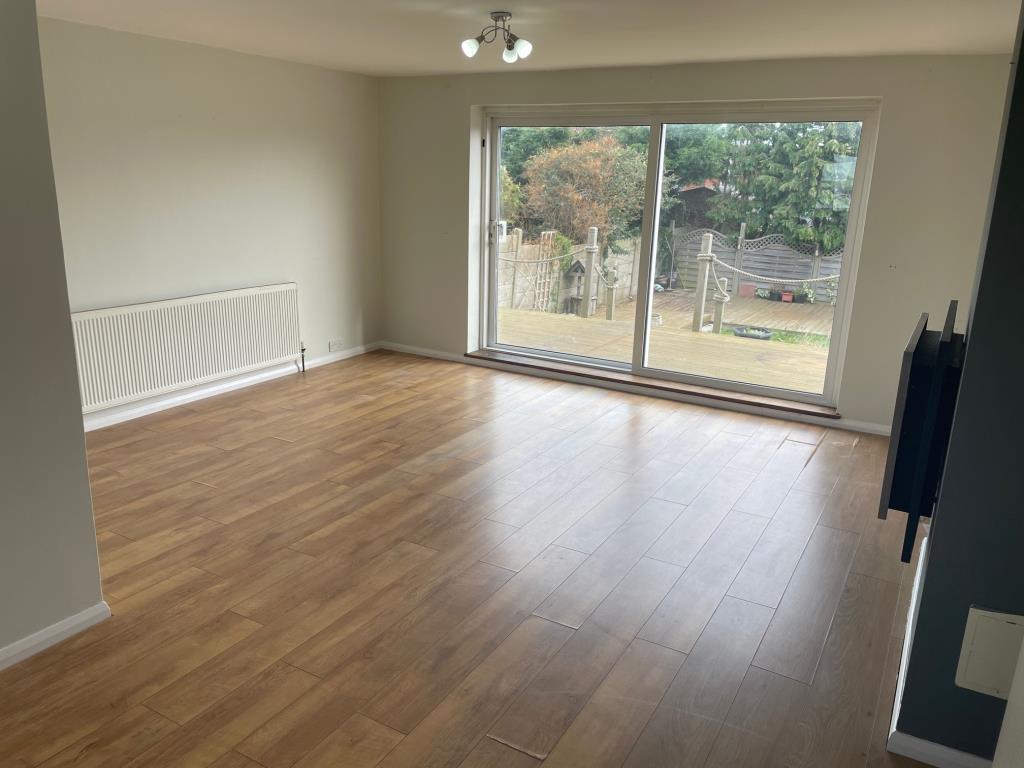 Lot: 107 - LINK-DETACHED THREE-BEDROOM HOUSE FOR REDECORATION - Living room looking towards rear garden